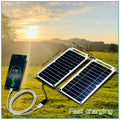 Solar panels charging a phone outdoors with a scenic background