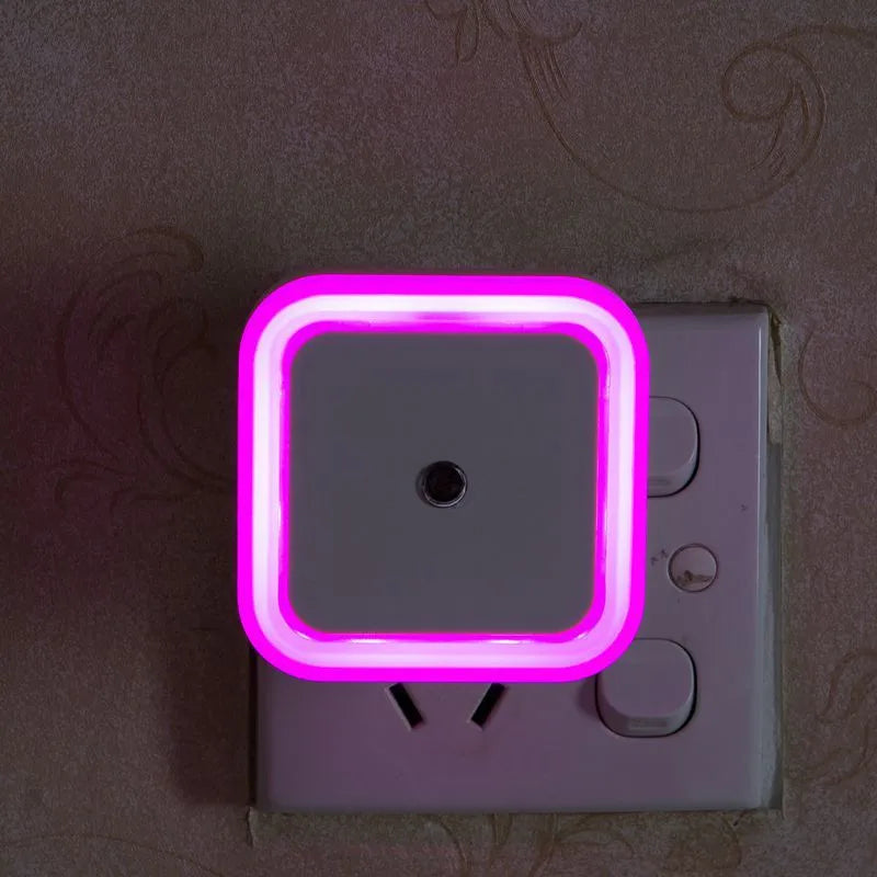 Neon light switch with pink border on a wall