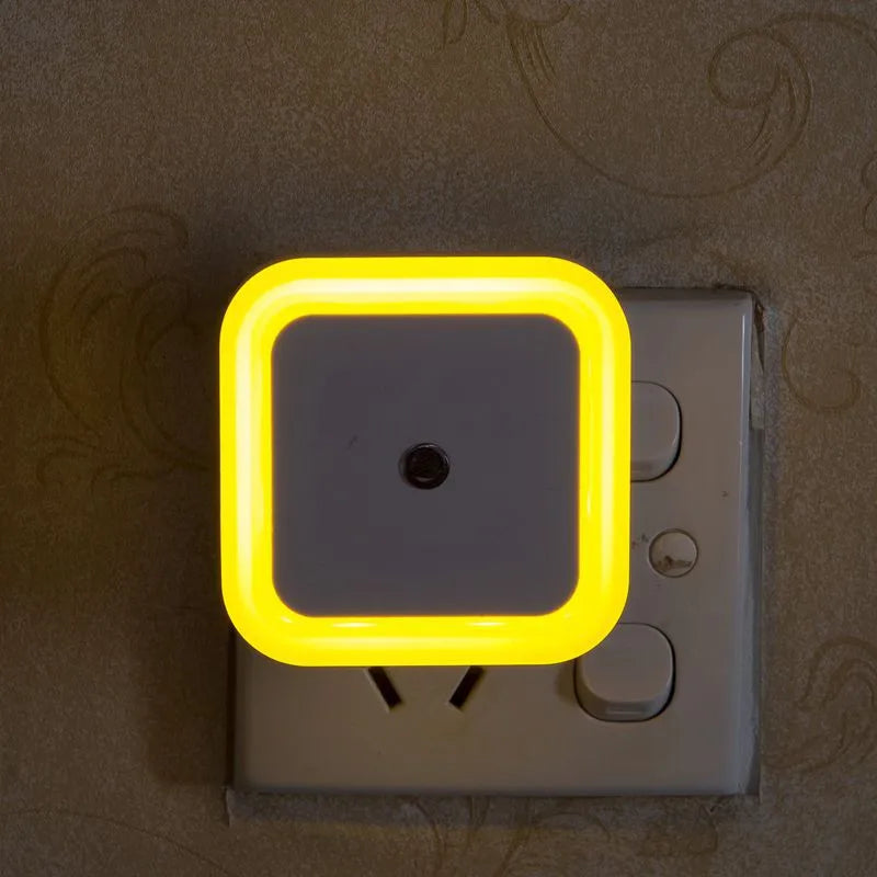 Neon light switch cover with yellow border on a wall switch.