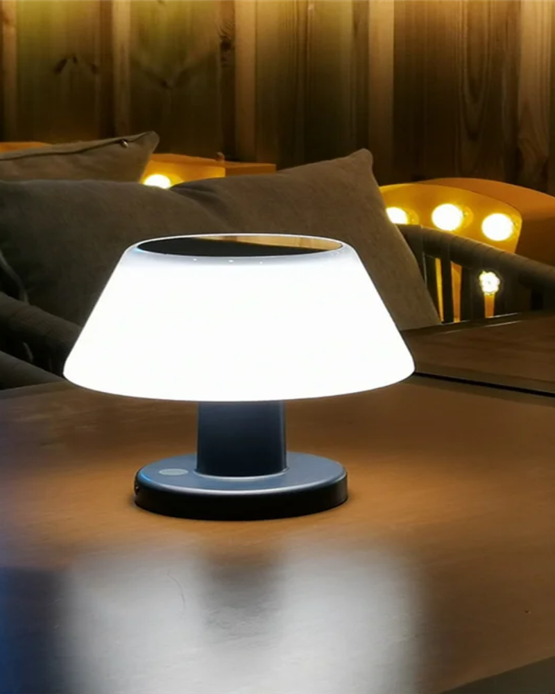 White outdoor lamp on a table with a cozy indoor background