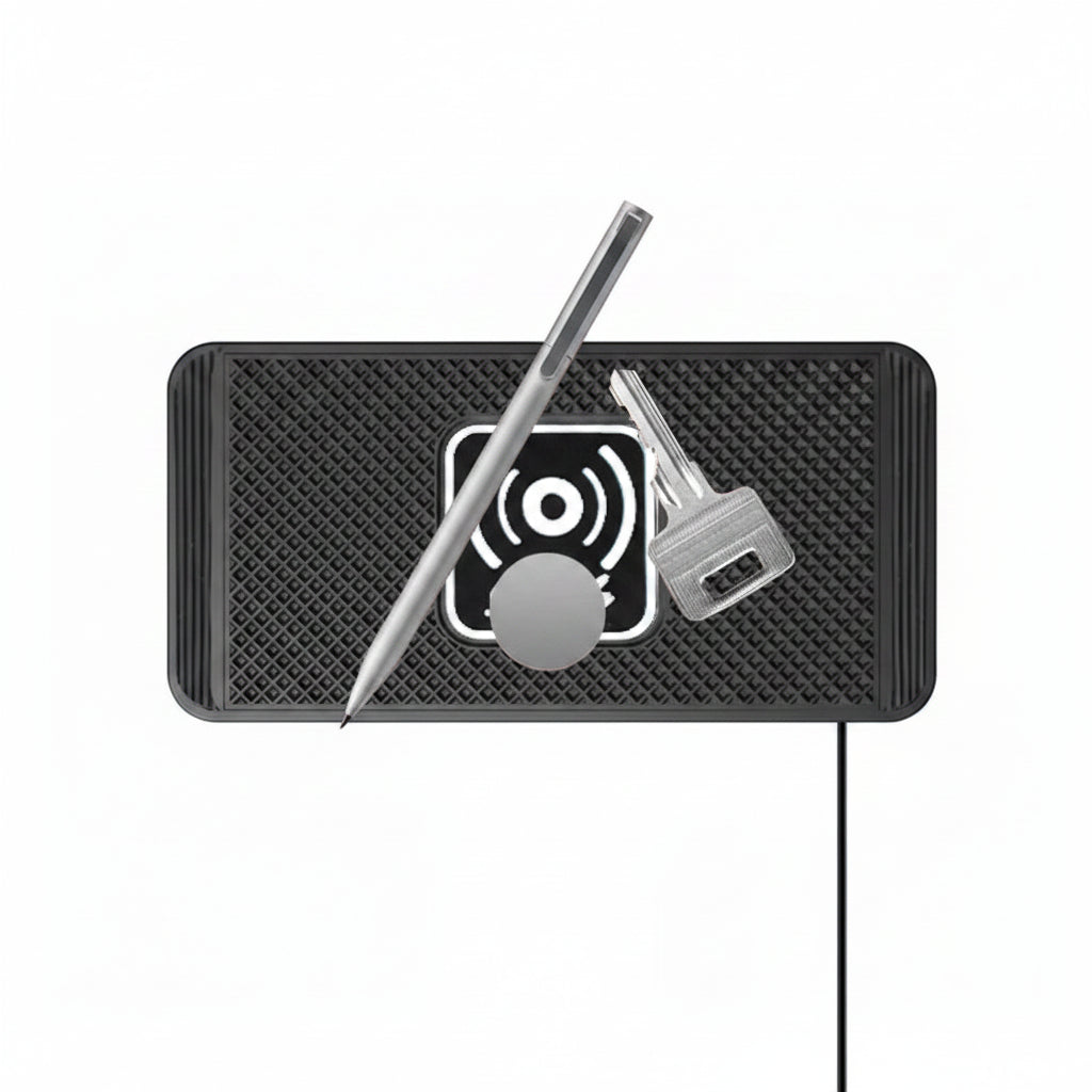 Black textured mat with a pen, key, and circular object on a white background