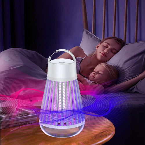 Fogging lamp on a table with people sleeping in the background, highlighting mosquito trapping feature.