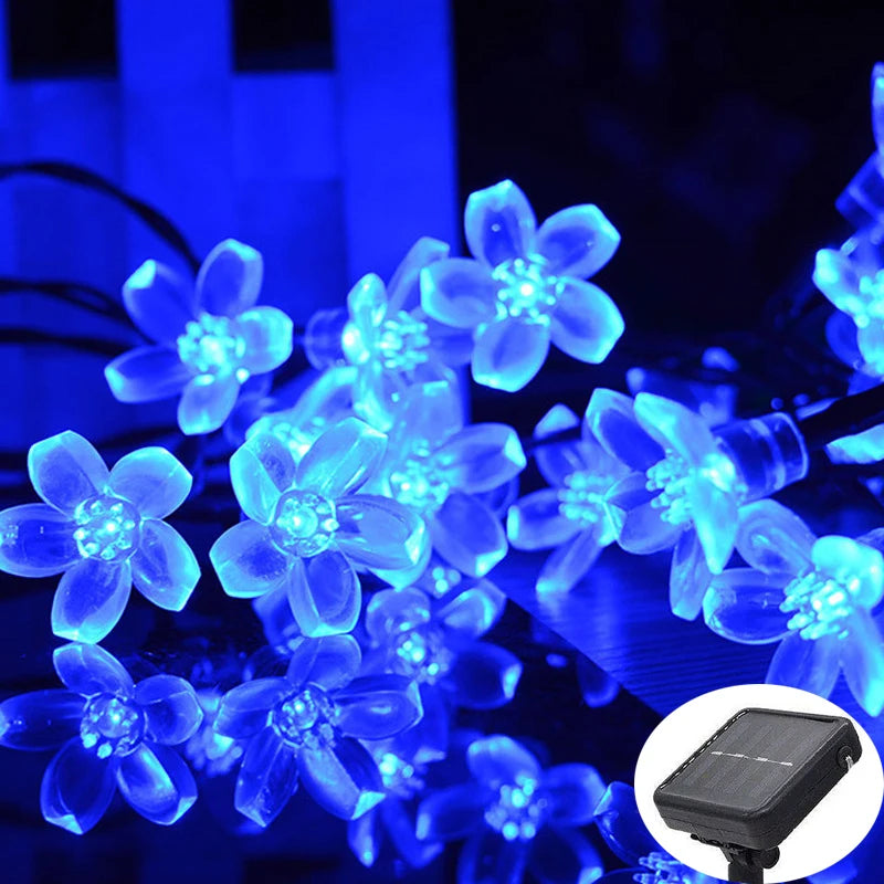 String of blue flower-shaped LED lights with a solar panel attachment.