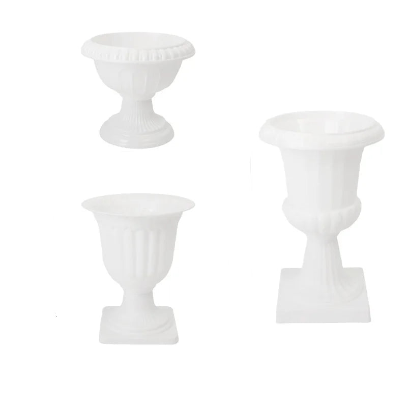 Three white decorative pedestal planters
