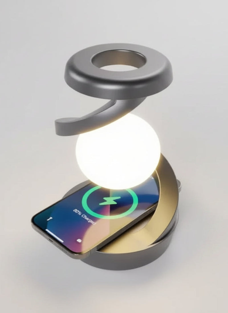 A silver and gold wireless phone charger with an integrated LED light, shown charging a smartphone.