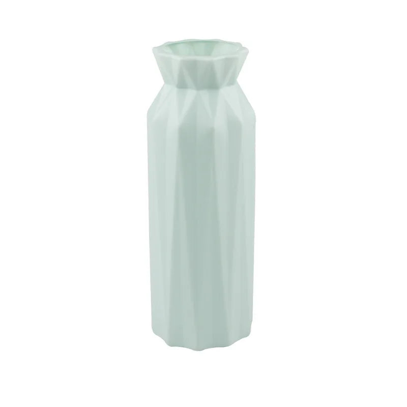 Light green hexagonal vase on a white background