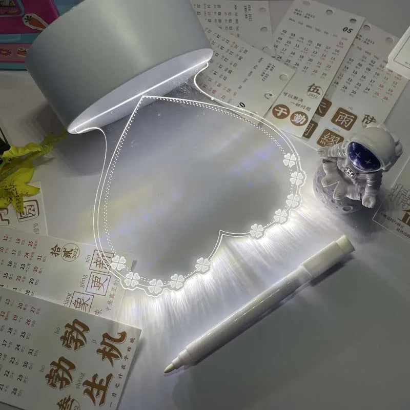 White LED light pad on a desk with a pen and stationery items.