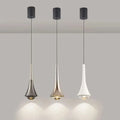 Three modern pendant lights hanging against a neutral background