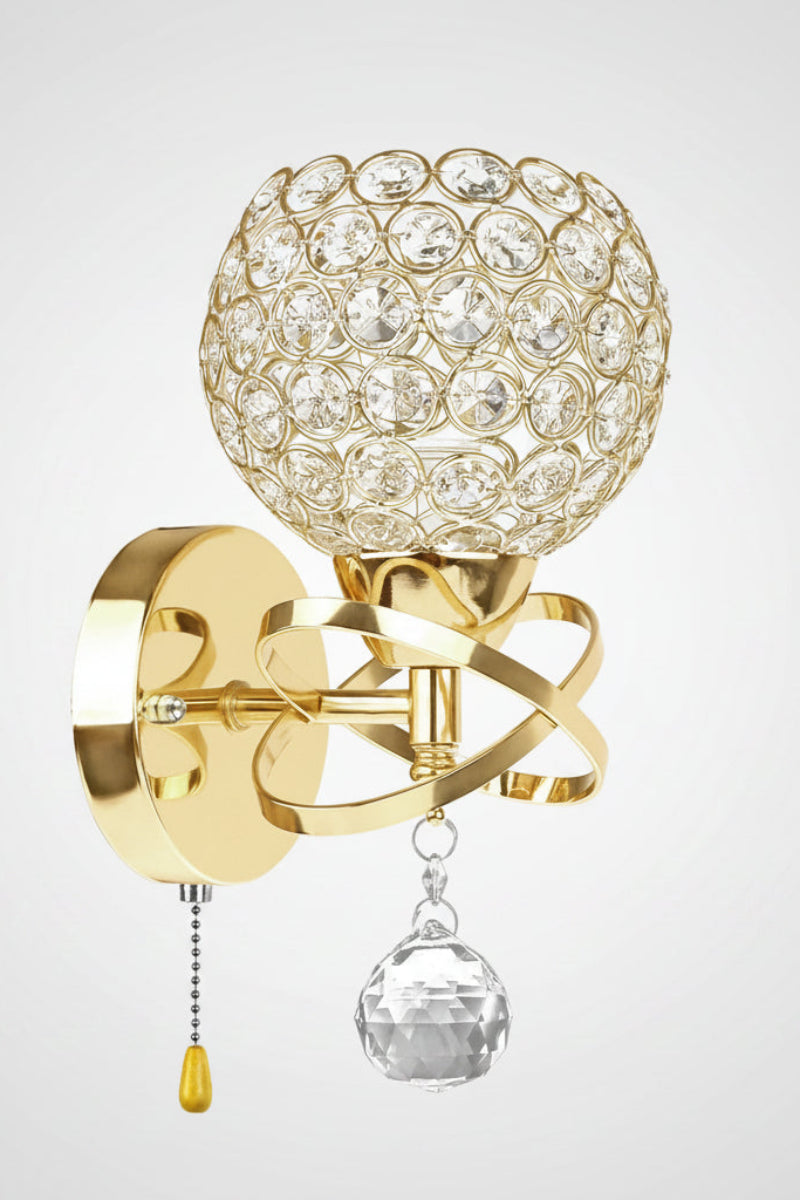 Decorative wall sconce with crystal ball and gold finish on a white background