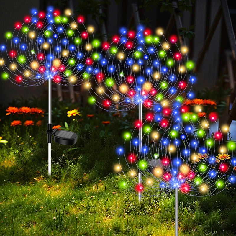 Colorful LED garden lights on stakes with a dark background