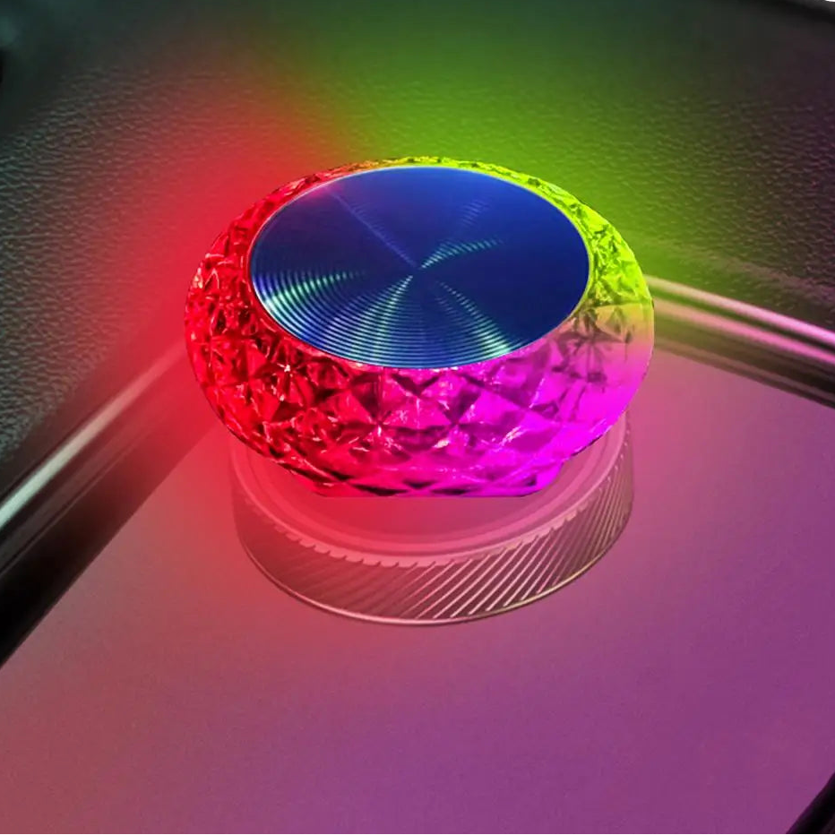 Colorful LED light on a reflective surface with a blurred background