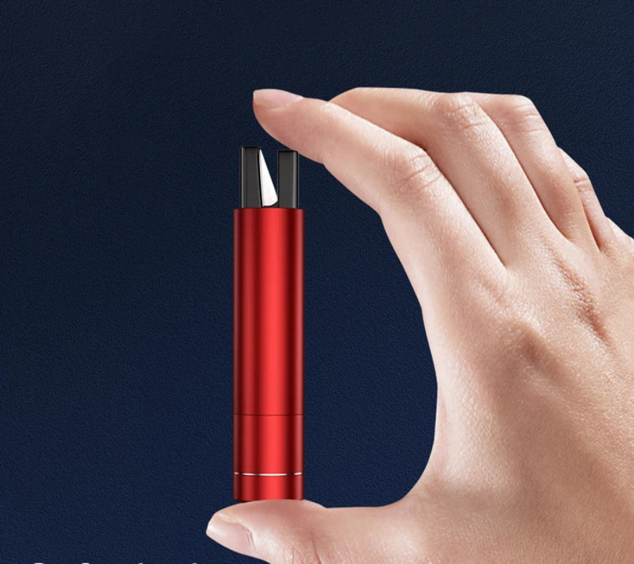 Hand holding a red and silver cylindrical object against a dark background