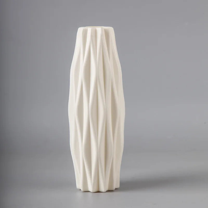 White ceramic vase with textured surface on a gray background