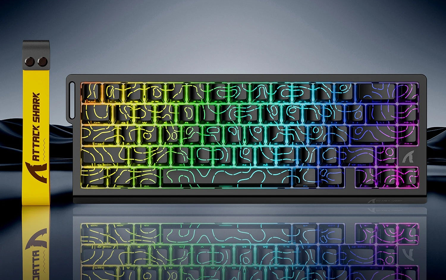 Mechanical keyboard with RGB lighting on a reflective surface, featuring Attack Shark branding.