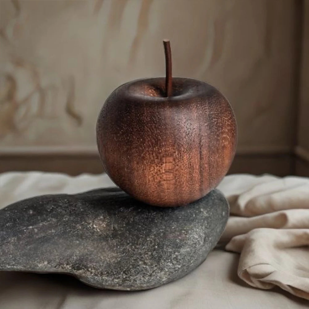 Rust-colored apple on a stone surface with a neutral background