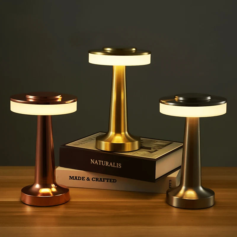 Three small lamps on a wooden surface with a dark background