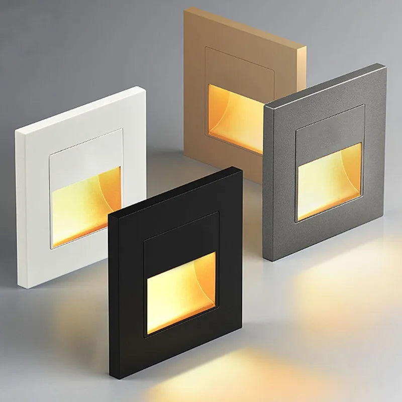 Four square LED lights in different colors on a gray background