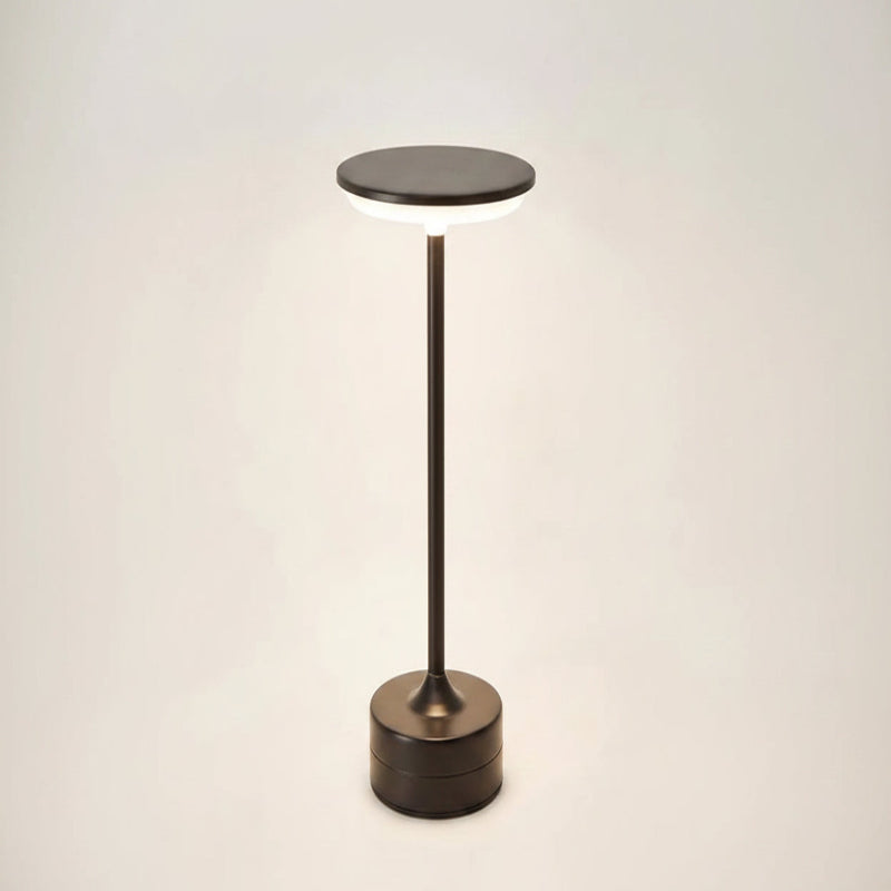Modern floor lamp with a round base and cylindrical shade on a light background