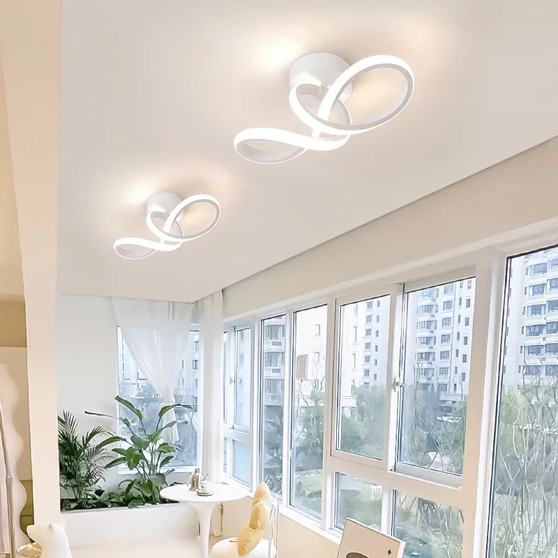 Modern living room with white ceiling lights and large windows.