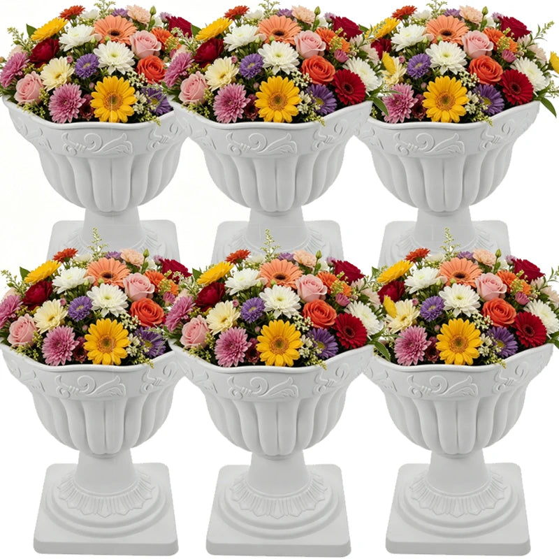 Six white decorative pedestal flower baskets arranged in two rows of three, each filled with a colorful bouquet of roses, chrysanthemums, and daisies on a plain white background.