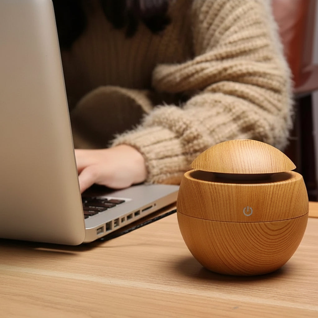 Wooden aromatherapy diffuser on a table with text about its functions.