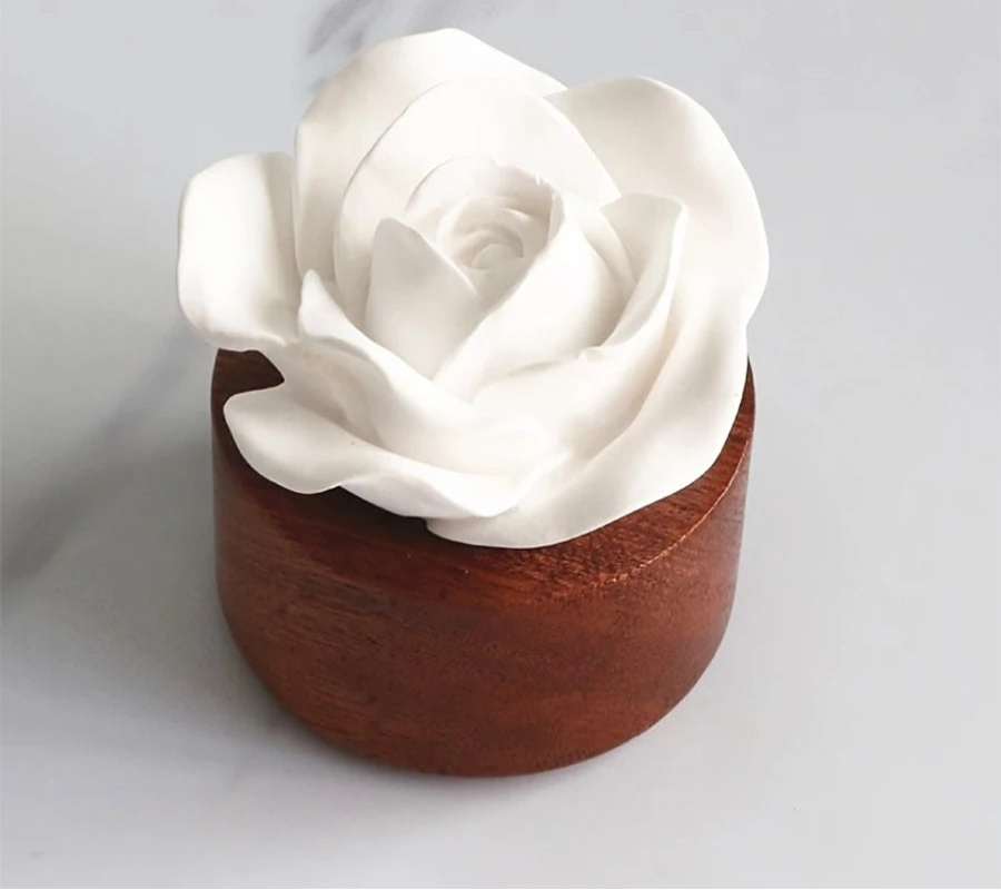 White rose-shaped container on a wooden base with text about odorless container.