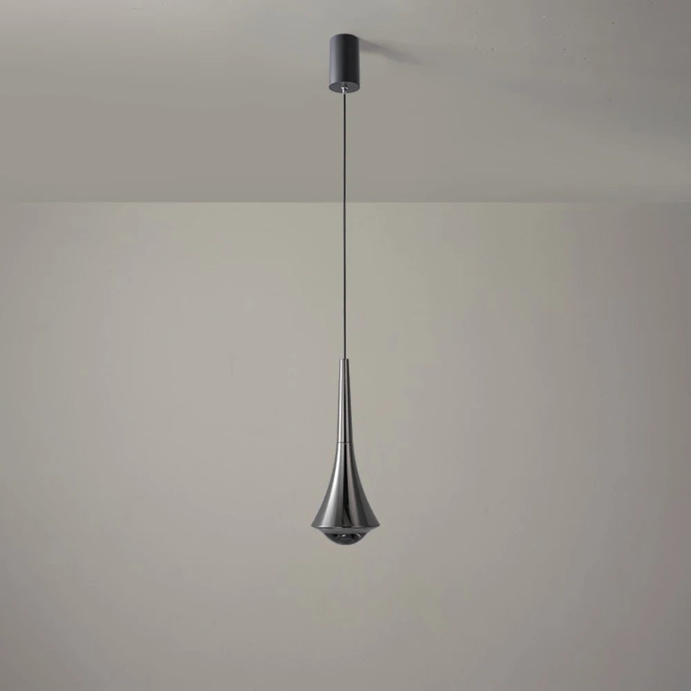 Modern pendant light hanging from a ceiling against a plain wall.