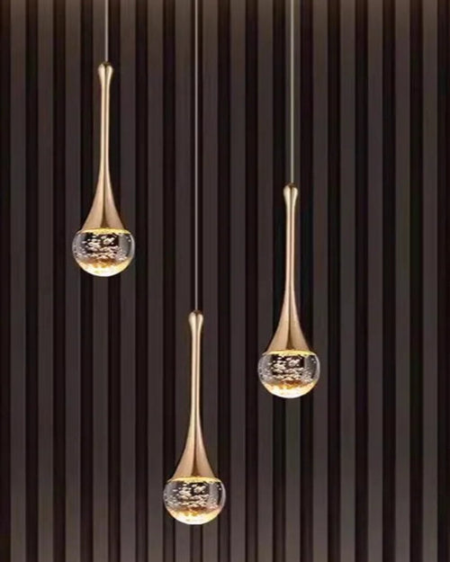 Three hanging gold crystal pendant lights against a dark background with 'Light of Time' branding.