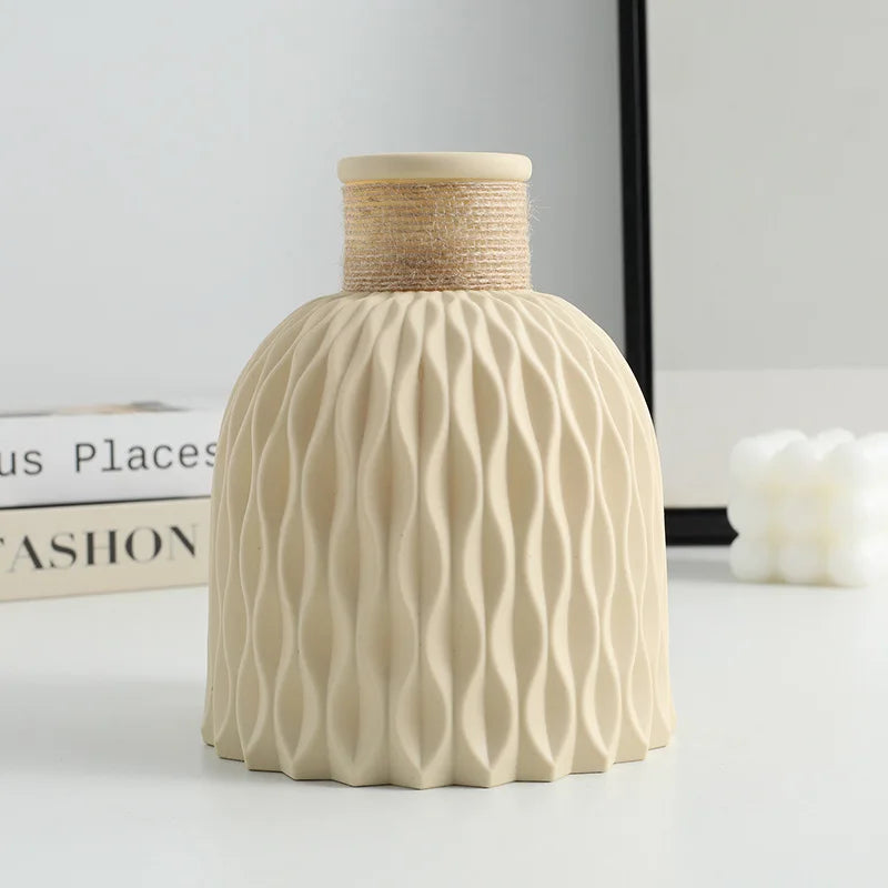 Beige textured vase with woven top on a light surface
