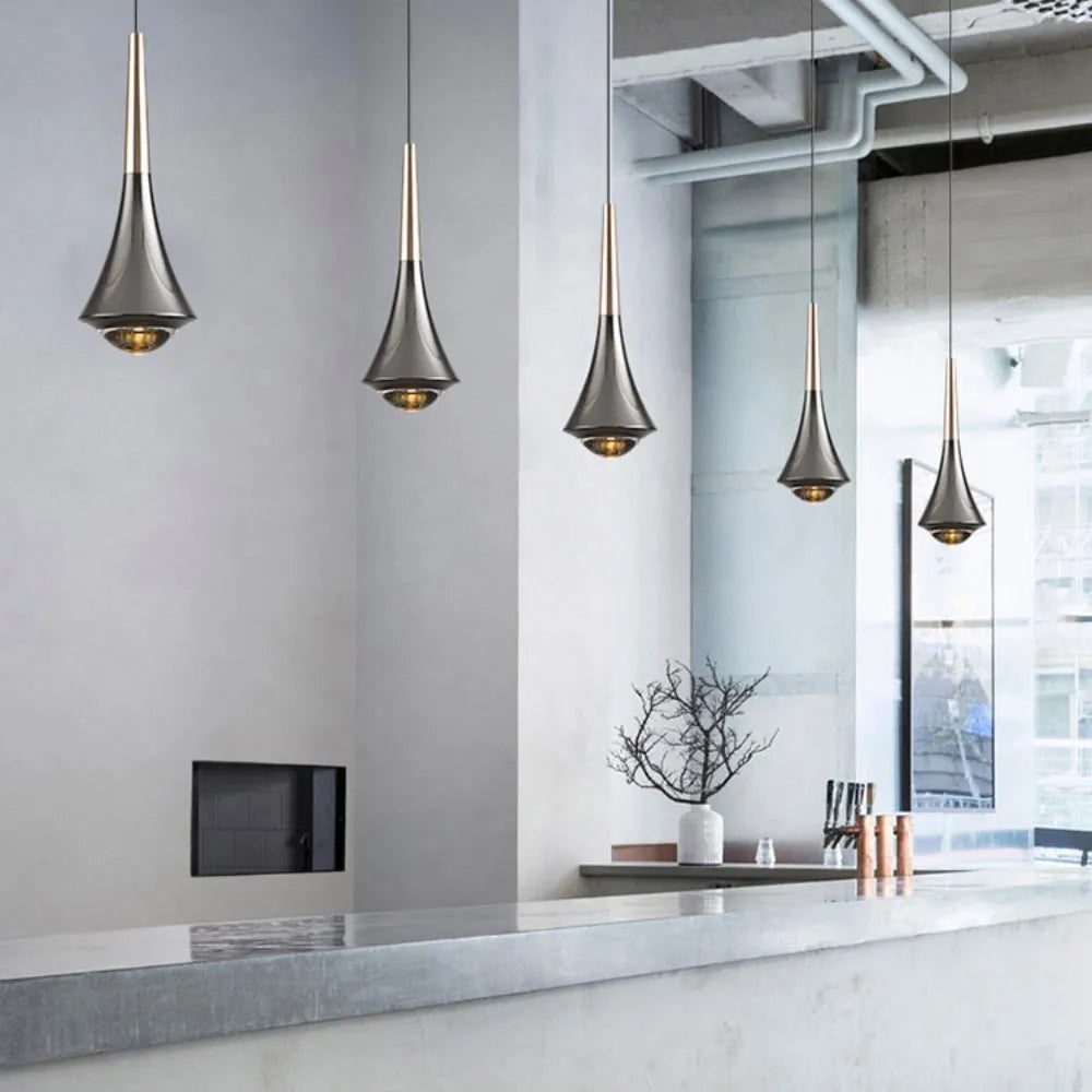 Modern kitchen with pendant lights hanging above a countertop.