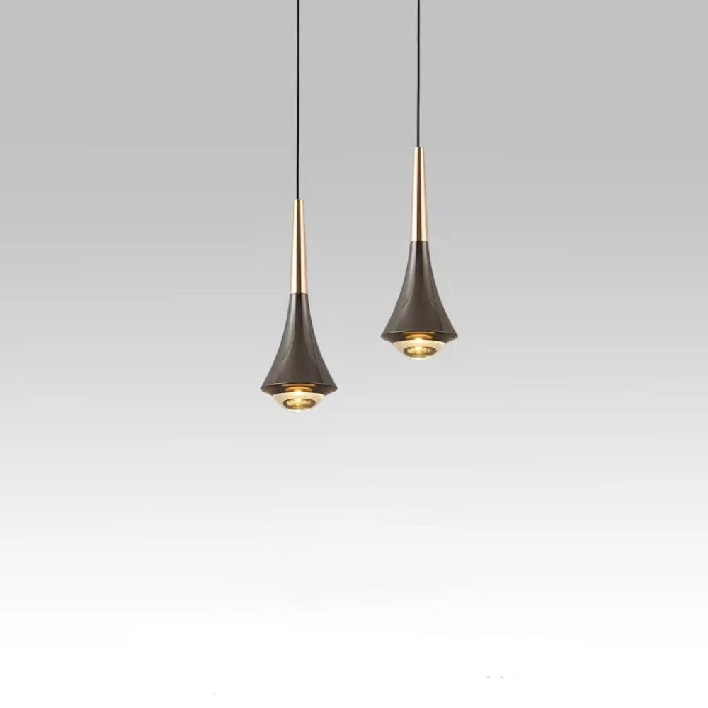 Two pendant lights hanging against a gray background with a quote below.