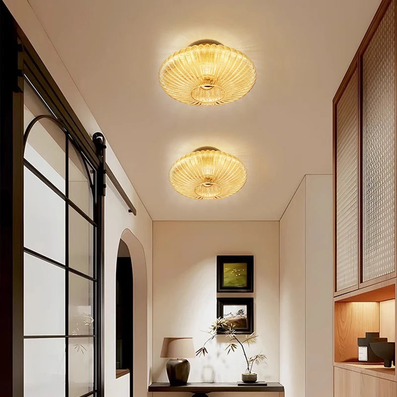 Modern interior hallway with gold ceiling lights and decorative elements.