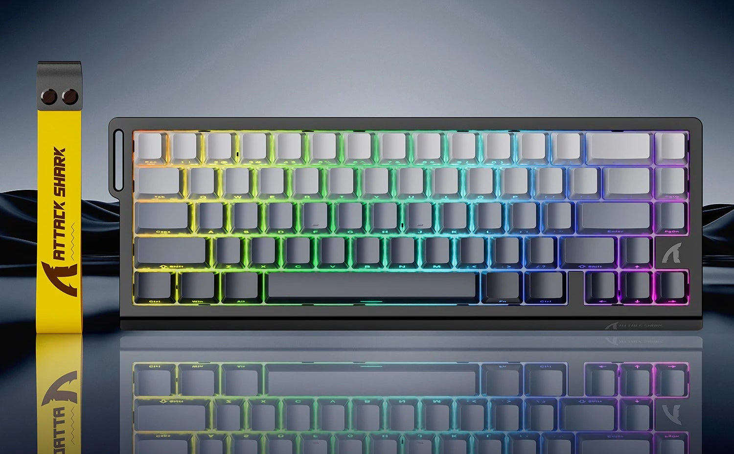 Mechanical keyboard with RGB lighting on a reflective surface, featuring the Attack Shark brand.