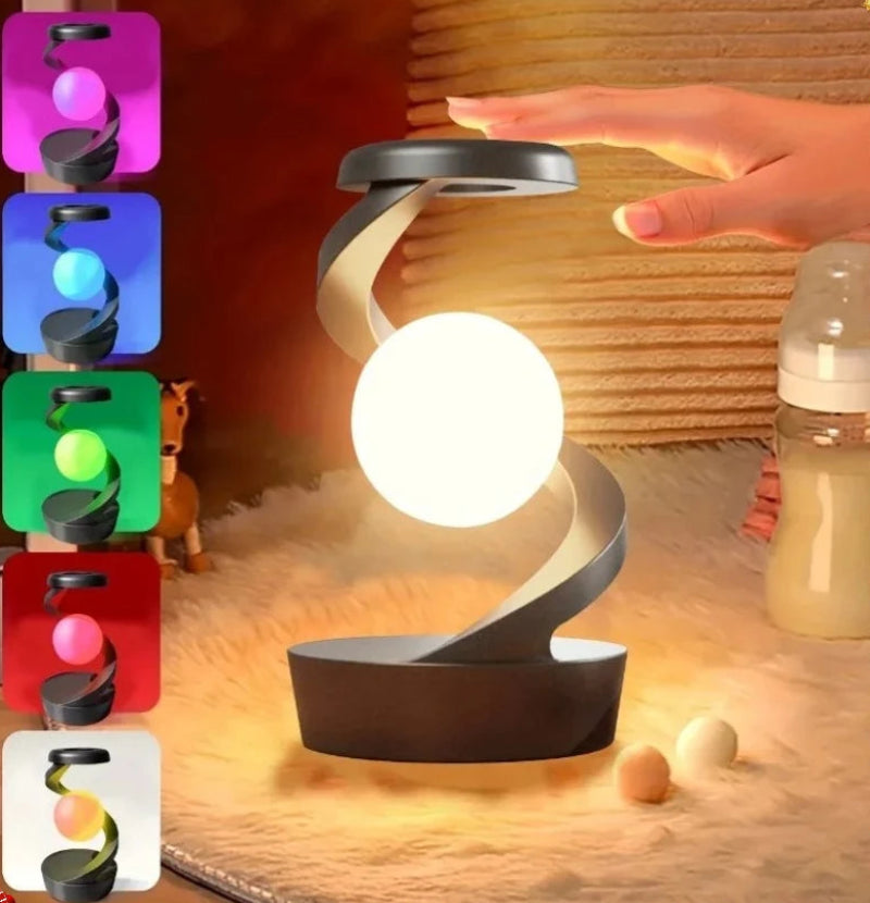 A modern spiral-shaped LED night light with a glowing white sphere in the center, shown in a home-like setting with a hand near the top and a baby bottle in the background. Color variant thumbnails are displayed on the left side.