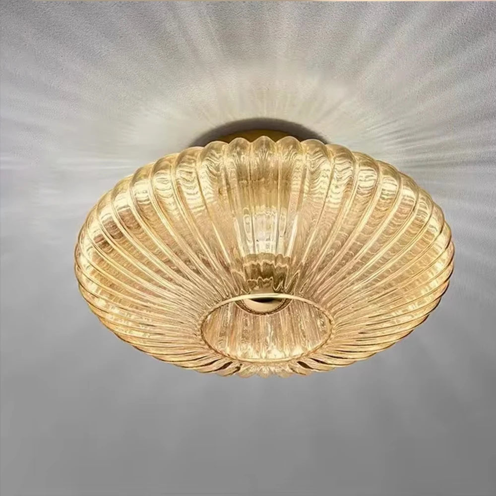 Gold ceiling light fixture on a gray background