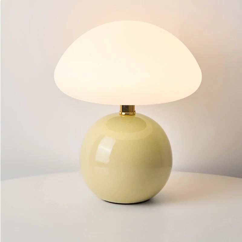Cream-colored table lamp with a white shade on a light gray background
