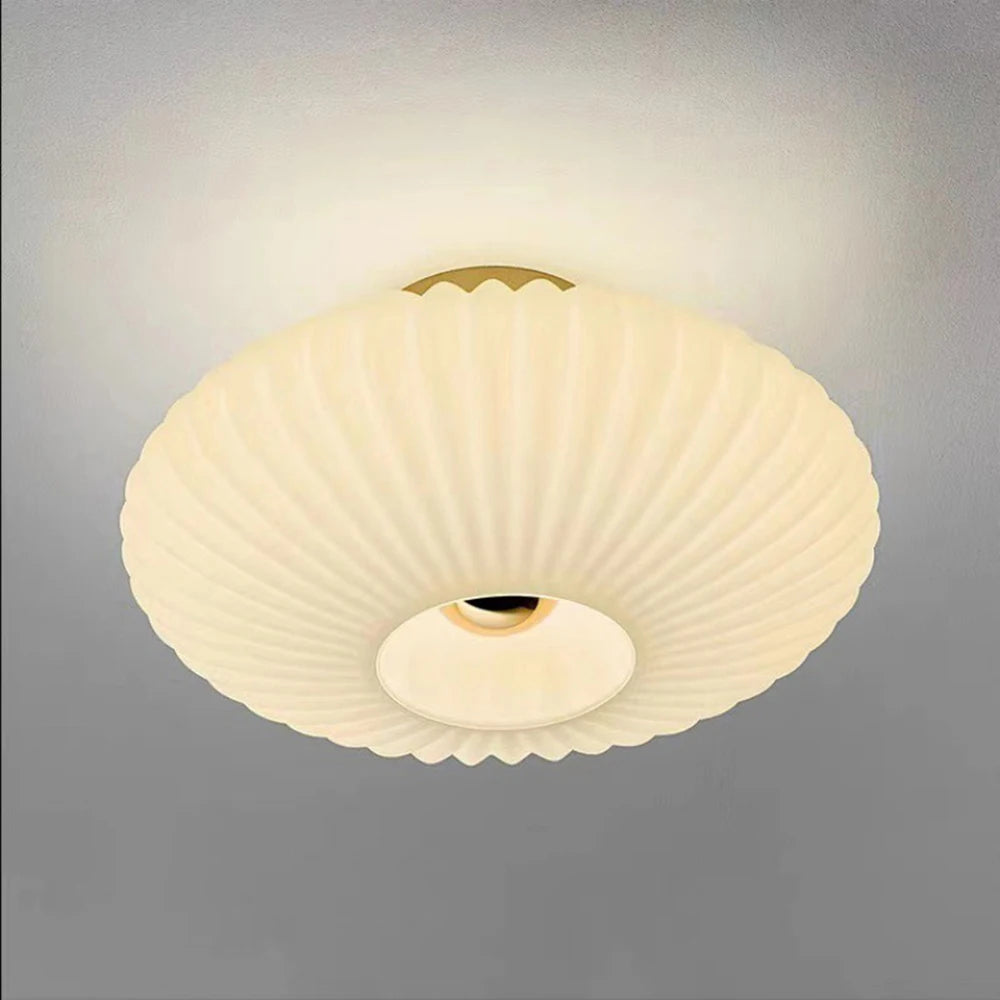 Ceiling light fixture with ribbed design on a gray background