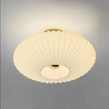 Ceiling light fixture with ribbed design on a gray background