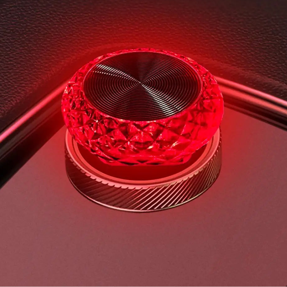 Red light bulb on a dark surface