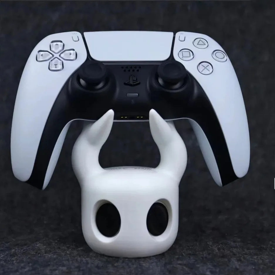 Gaming controller with a white and black design, featuring horns, on a dark background.