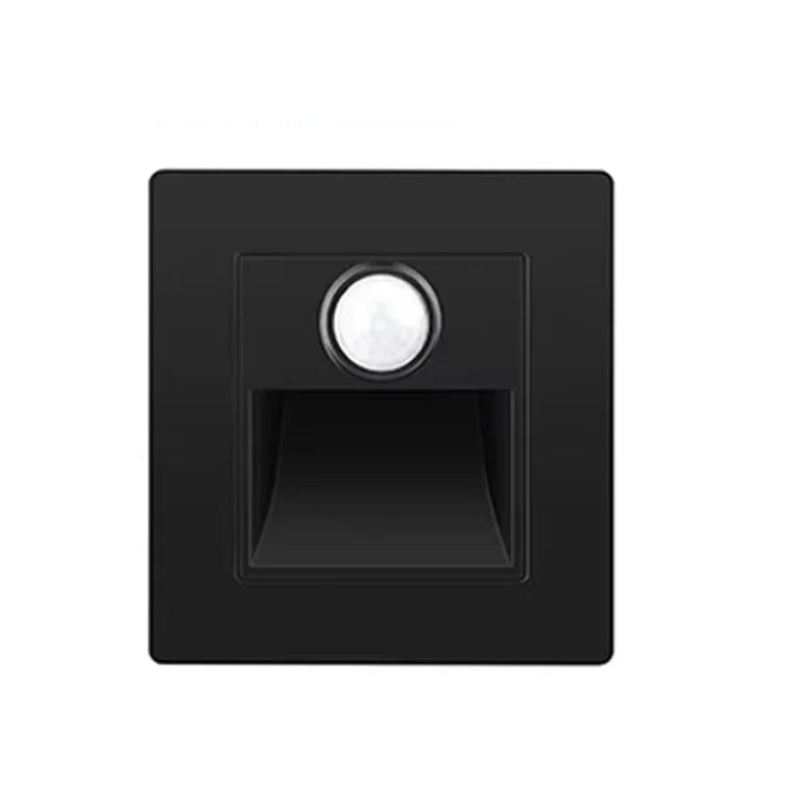 Black infrared motion sensor with a white label on a white background