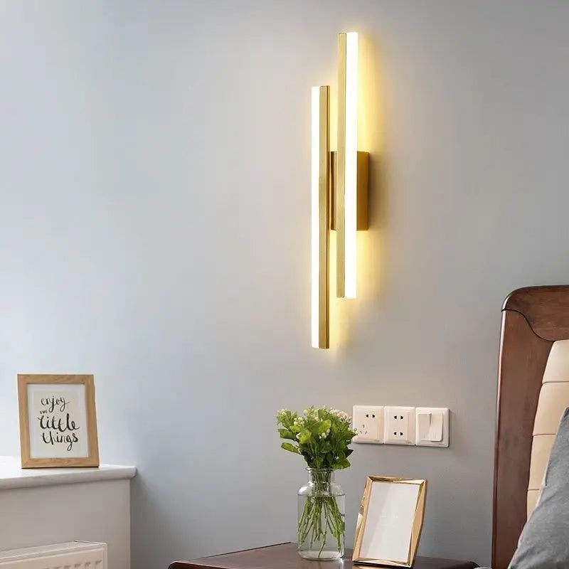 Modern wall-mounted light fixture on a gray wall with decorative elements.