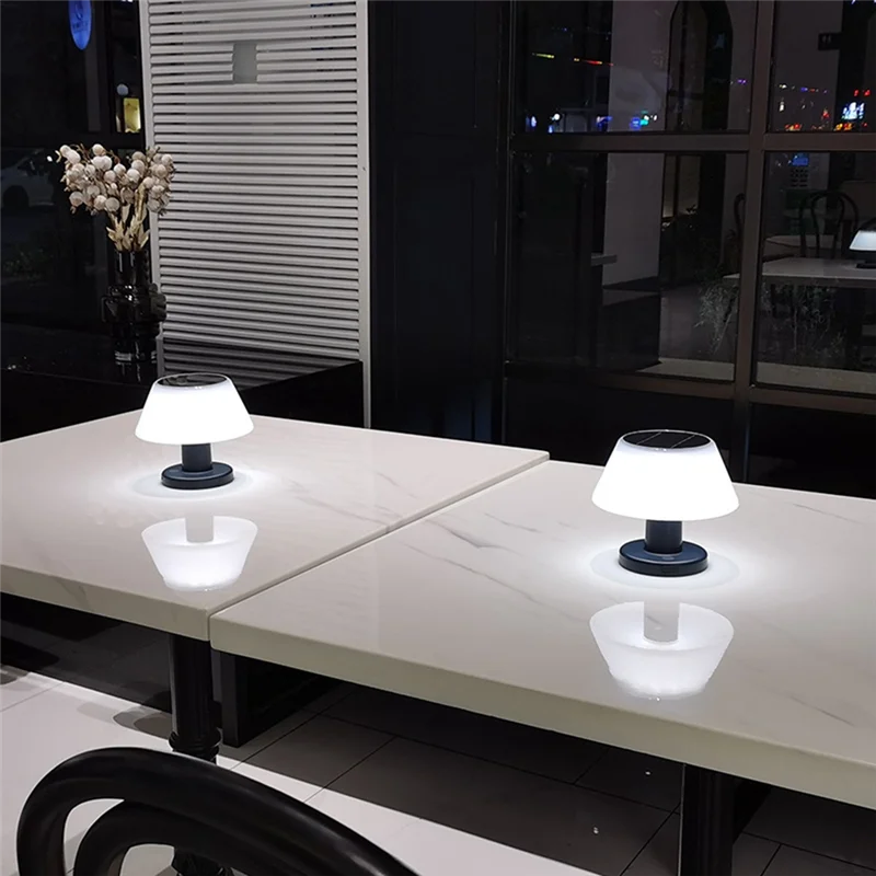 Two small table lamps on a modern dining table with a blurred background