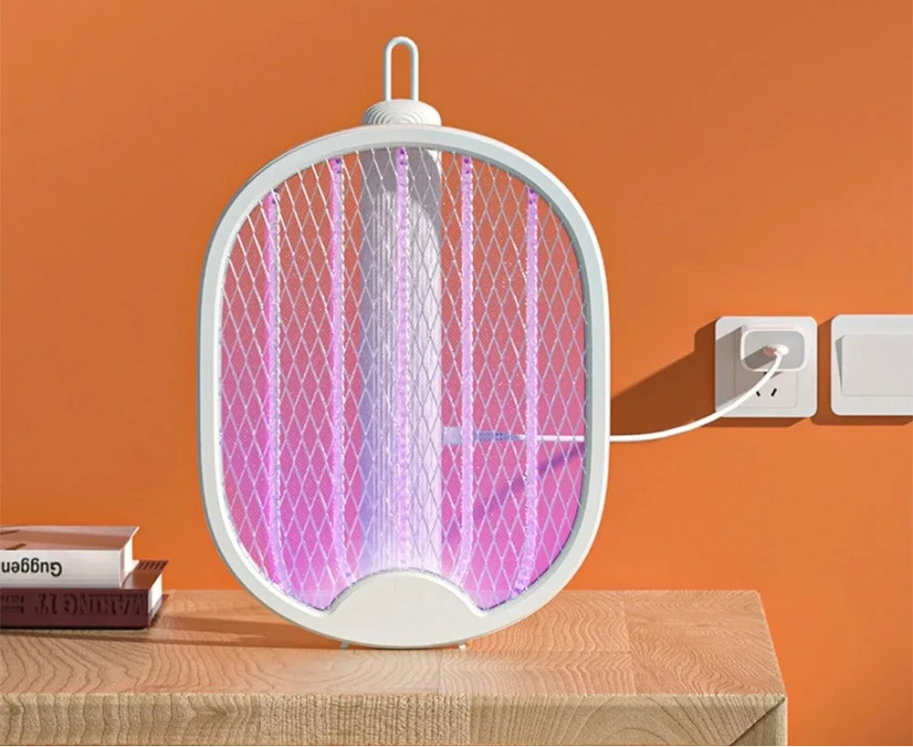Electronic mosquito killer on a wooden surface with an orange background