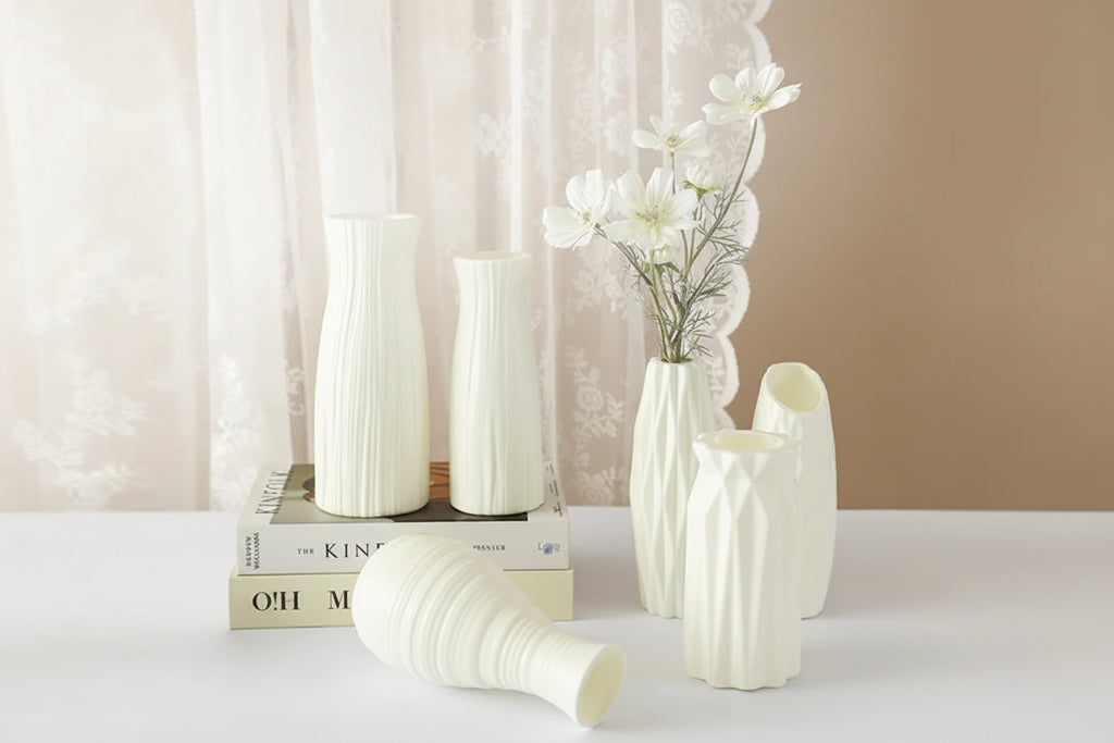 Set of white vases with a minimalistic design on a neutral background