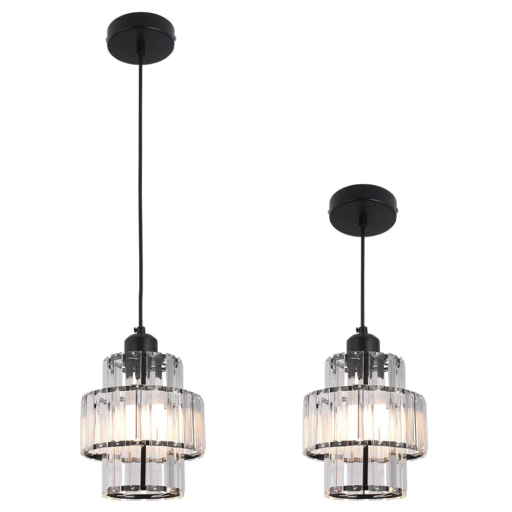 Two pendant lights with clear glass shades and black metal fixtures