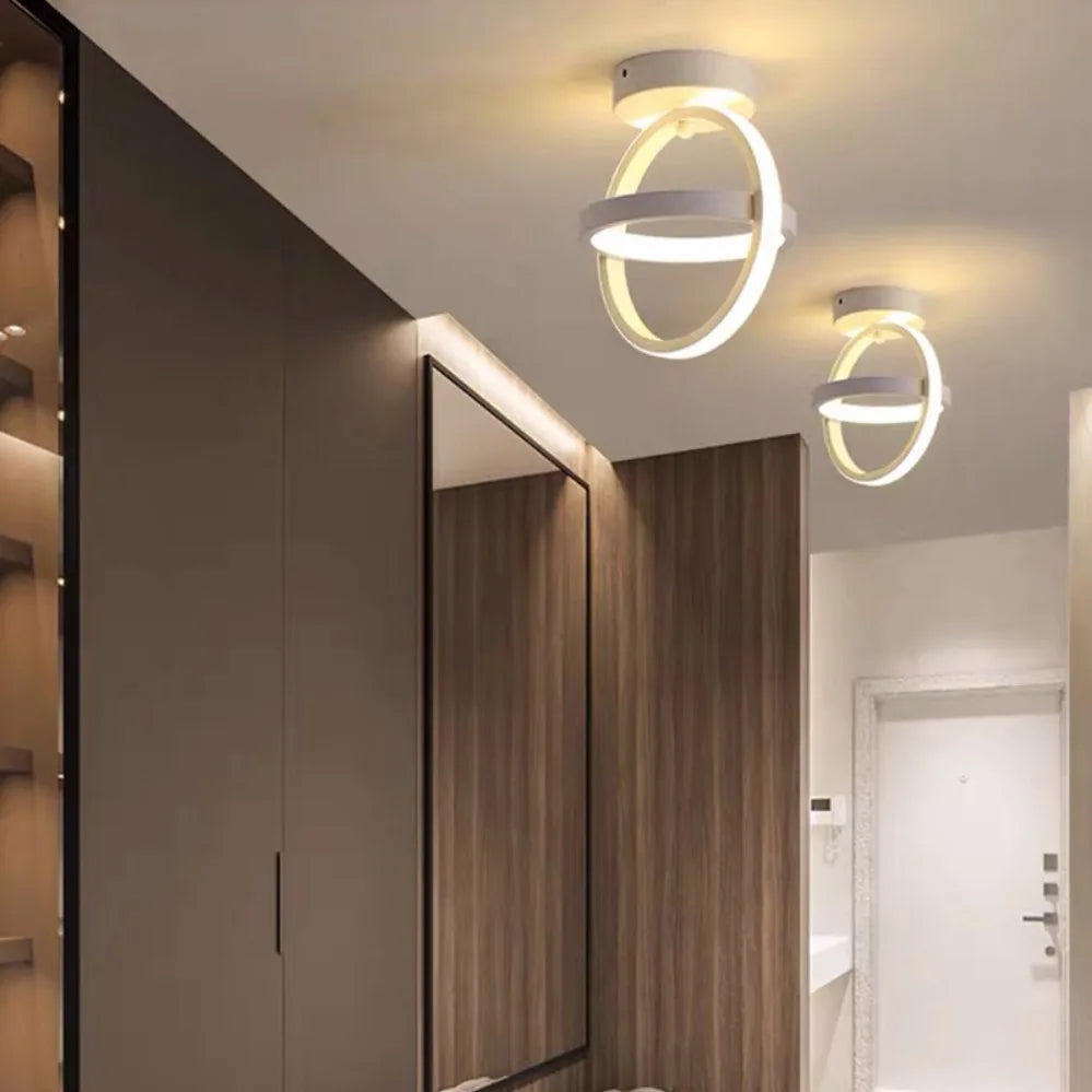 Modern ceiling lights in a room with wooden paneling and a mirror.