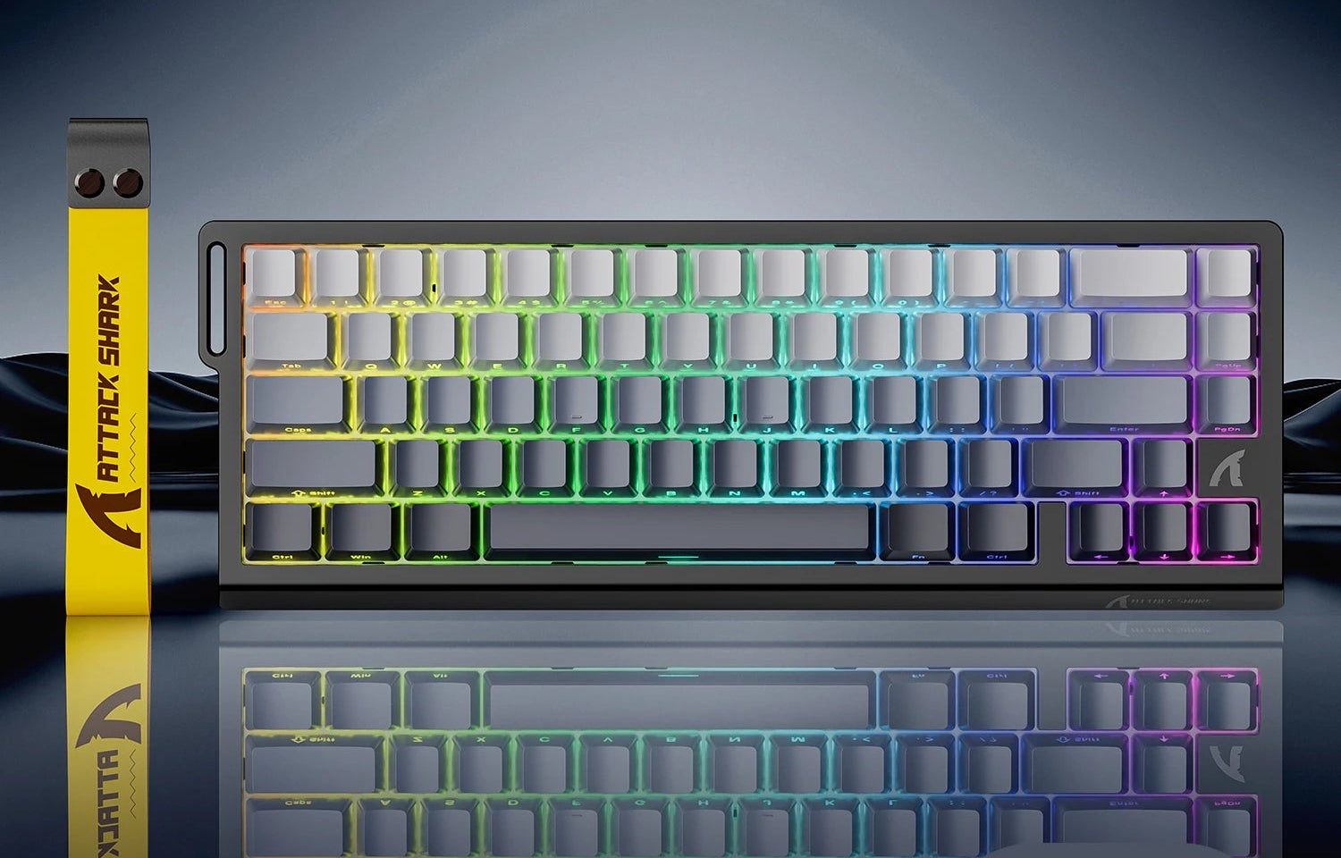 Mechanical keyboard with RGB lighting on a reflective surface, featuring the Attack Shark brand.