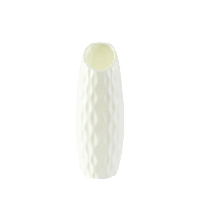White ceramic vase with a textured surface on a white background