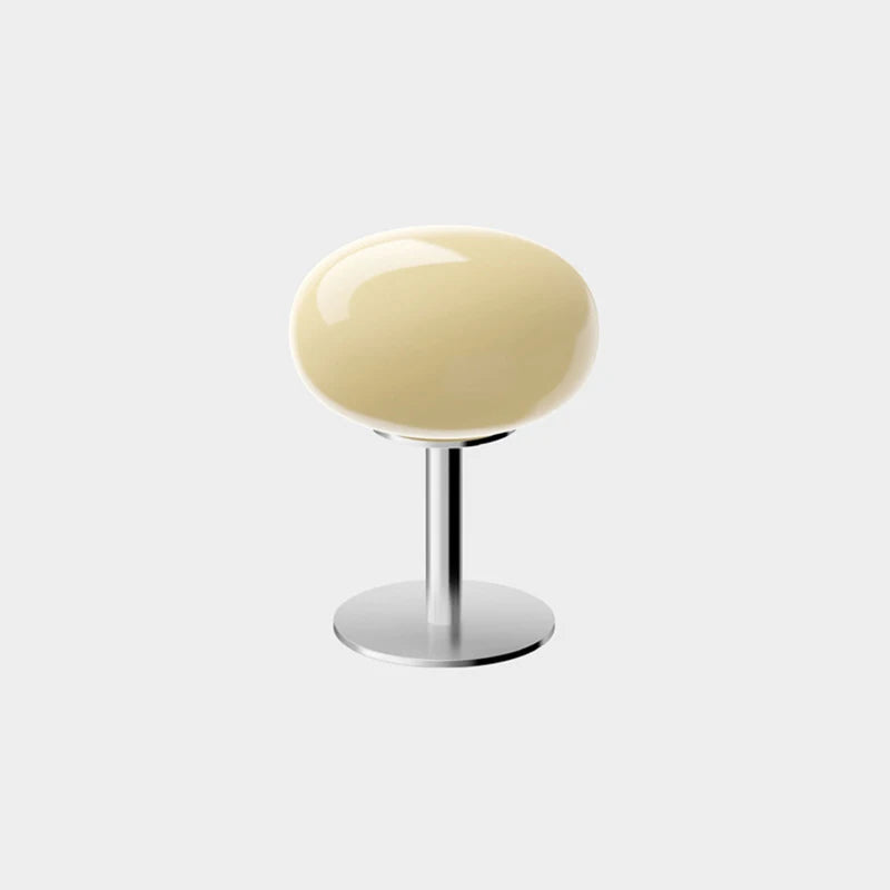 Modern stool with a round beige seat and metallic base on a white background